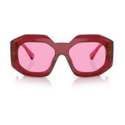 Solbriller med uregelmæssig form, fuchsia linse og transparent rød ste...