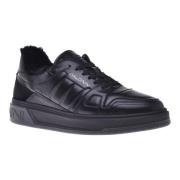 Trainers in black quilted leather